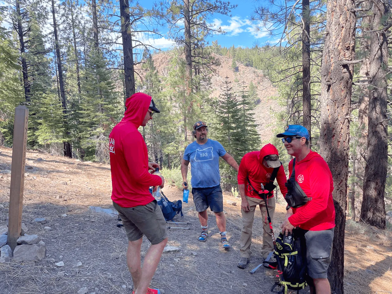 Team members gathered at a trailhead