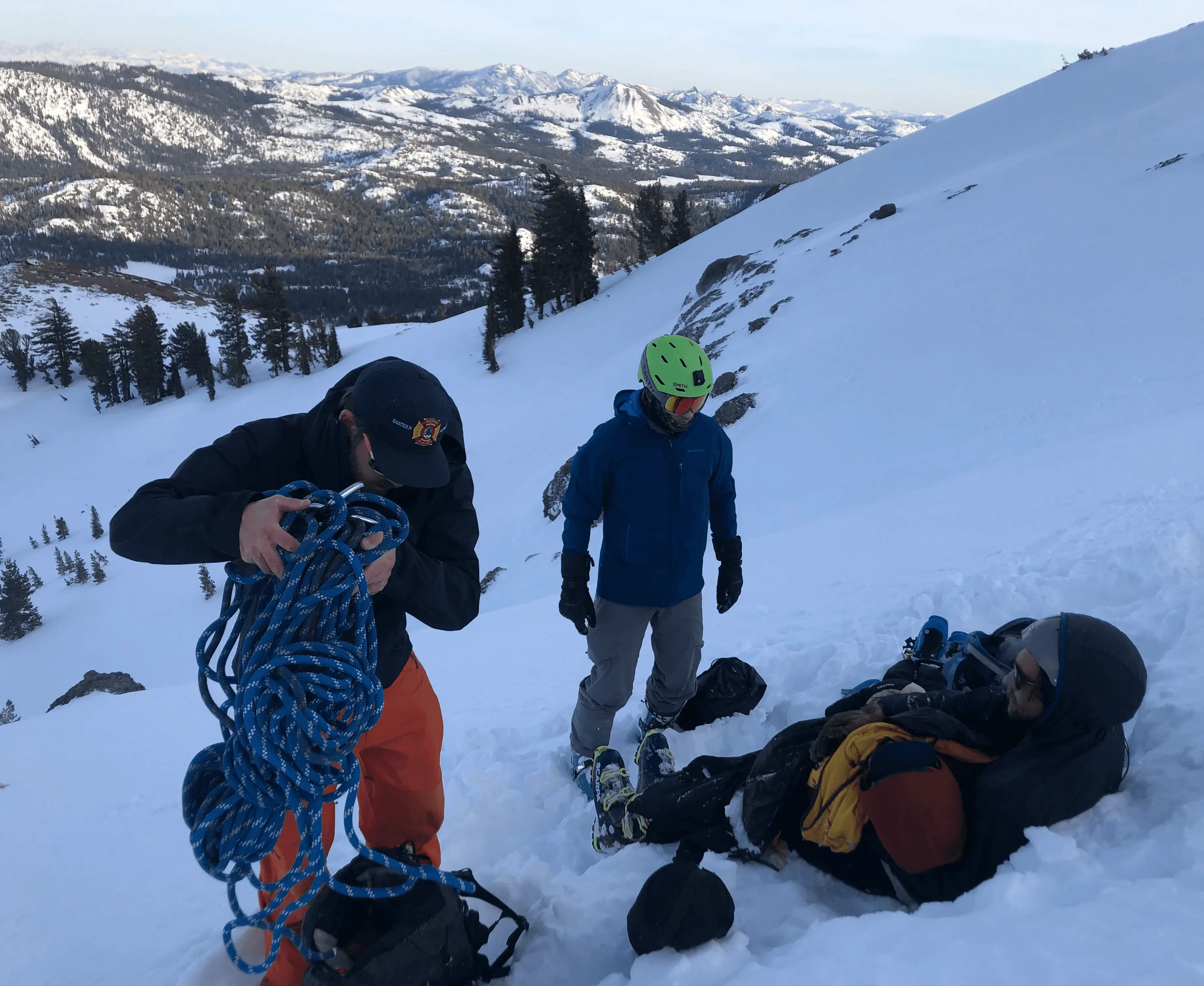 Volunteers with rope gear on a snow slope